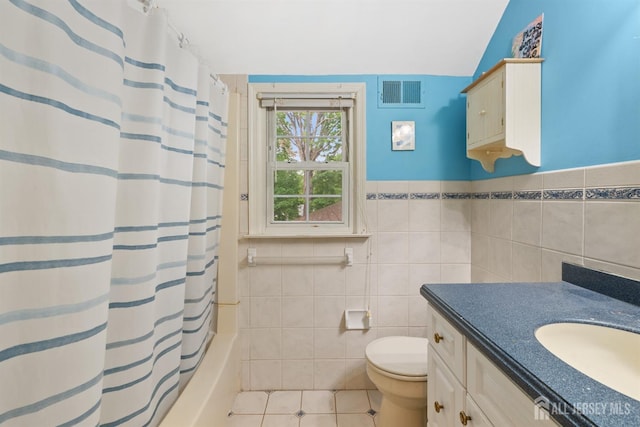 22 S Drive E, Brunswick, NJ 08816 - full bathroom with tile walls, toilet, vanity, tile patterned flooring, and shower / bathtub combination with curtain