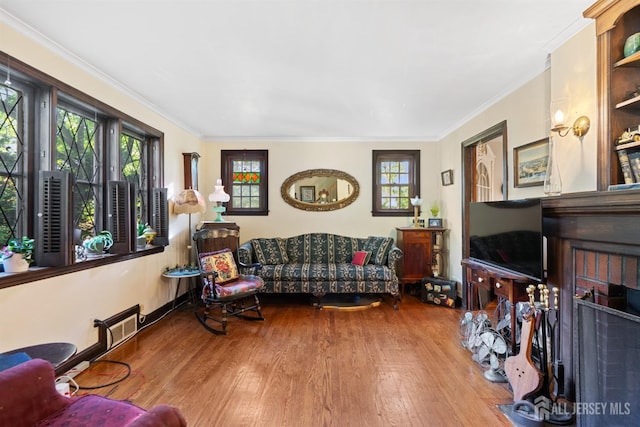 22 S Drive E, Brunswick, NJ 08816 - living room featuring healthy amount of natural light, wood finished floors, and ornamental molding