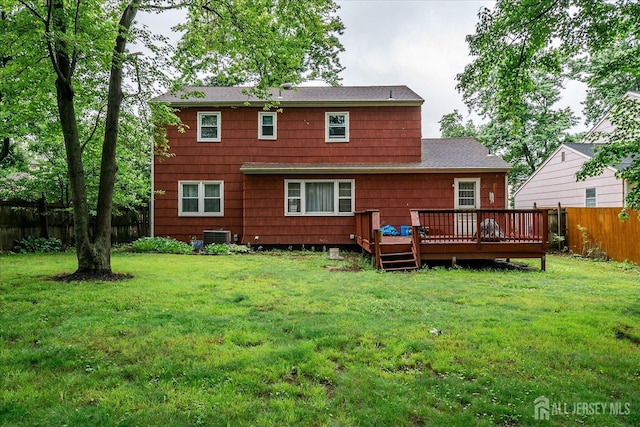 10 Ginesi Ct, Metuchen, NJ 08840 - back of house featuring a fenced backyard, a wooden deck, and roof with shingles