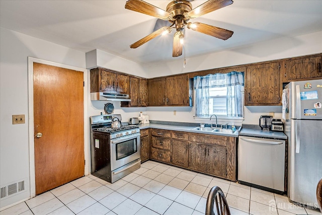 10 Ginesi Ct, Metuchen, NJ 08840 - kitchen with appliances with stainless steel finishes, ceiling fan, light tile patterned floors, and under cabinet range hood