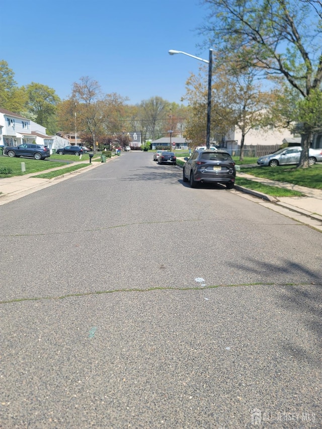 10 Ginesi Ct, Metuchen, NJ 08840 - view of asphalt road featuring sidewalks, curbs, and street lights