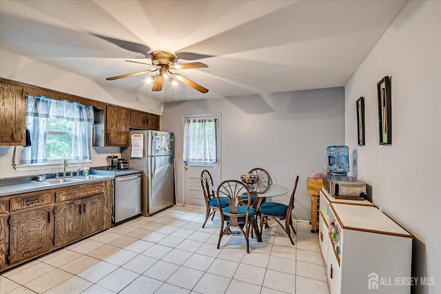 10 Ginesi Ct, Metuchen, NJ 08840 - kitchen with appliances with stainless steel finishes, a ceiling fan, healthy amount of natural light, and light tile patterned floors