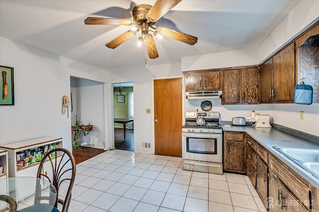 10 Ginesi Ct, Metuchen, NJ 08840 - kitchen with stainless steel range with gas stovetop, range hood, ceiling fan, and light tile patterned floors