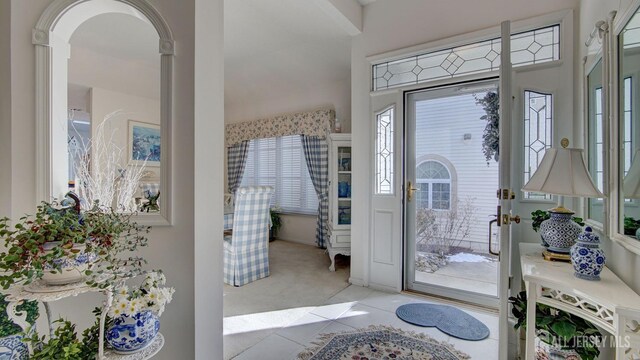 foyer with light colored carpet