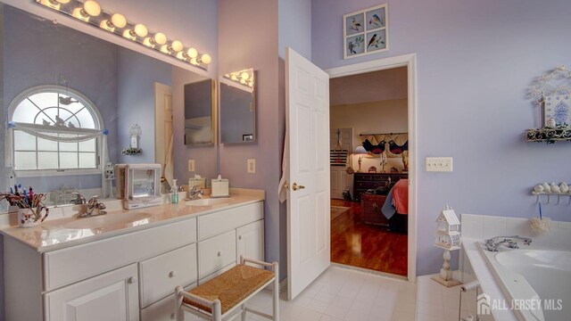 bathroom with a bathtub, tile patterned floors, and vanity