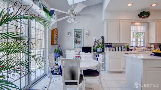 kitchen featuring ceiling fan, white cabinetry, white dishwasher, and light tile patterned floors