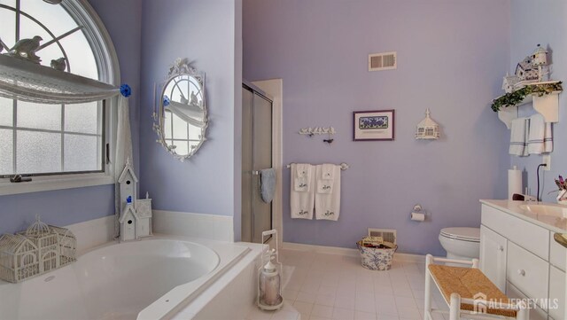 full bathroom featuring toilet, shower with separate bathtub, a wealth of natural light, and vanity