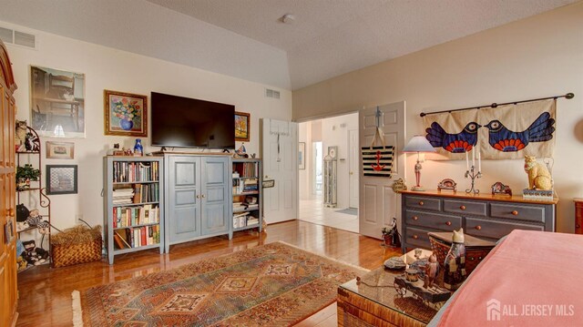 bedroom featuring a textured ceiling and hardwood / wood-style floors