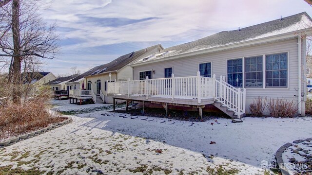 snow covered property featuring a wooden deck