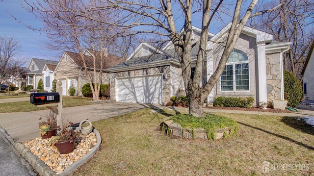 view of front facade featuring a front yard and a garage