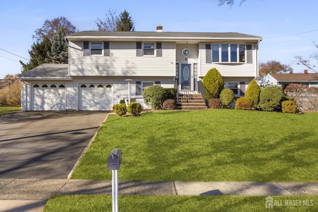 split foyer home featuring a front lawn and a garage