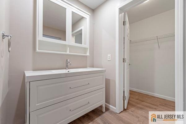 bathroom with vanity and hardwood / wood-style floors