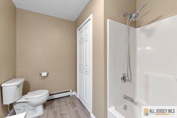 bathroom with hardwood / wood-style flooring, shower / bathtub combination, toilet, and a baseboard heating unit