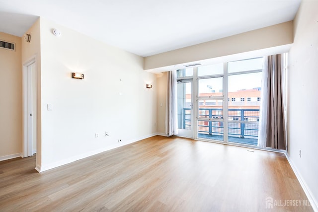 20 Livingston Ave Unit 504, New Brunswick, NJ 08901 - spare room featuring light wood-style floors and a smoke detector