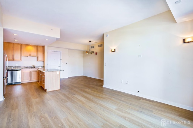 20 Livingston Ave Unit 504, New Brunswick, NJ 08901 - kitchen featuring stainless steel dishwasher, light wood-type flooring, recessed lighting, a kitchen island, and light stone countertops