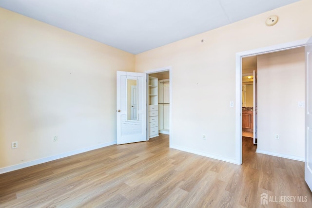 20 Livingston Ave Unit 504, New Brunswick, NJ 08901 - unfurnished bedroom with light wood-style floors, a spacious closet, and a closet