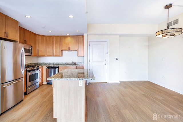 20 Livingston Ave Unit 504, New Brunswick, NJ 08901 - kitchen with appliances with stainless steel finishes, light stone countertops, light wood-style floors, recessed lighting, and a kitchen island
