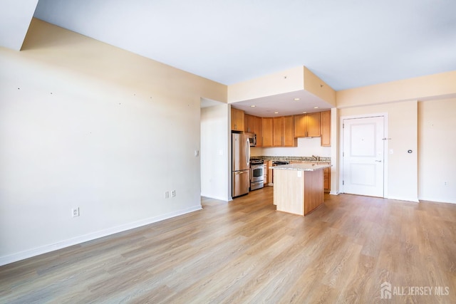 20 Livingston Ave Unit 504, New Brunswick, NJ 08901 - kitchen featuring stainless steel appliances, light wood finished floors, open floor plan, and a center island