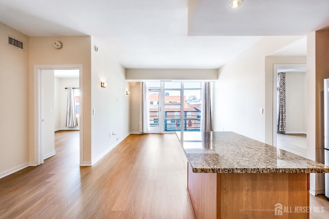 20 Livingston Ave Unit 504, New Brunswick, NJ 08901 - kitchen with light wood-type flooring, stone countertops, and a center island
