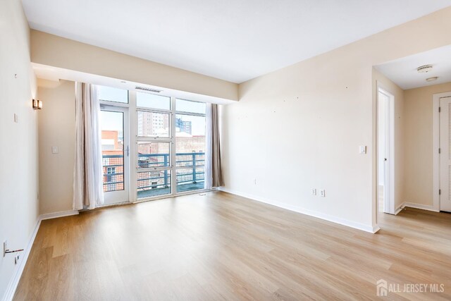 20 Livingston Ave Unit 504, New Brunswick, NJ 08901 - empty room with light wood-style flooring and a smoke detector