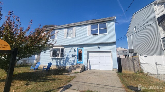 view of front of home featuring a garage and a front lawn