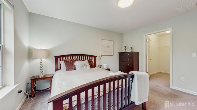 612 Magnolia Rd, North Brunswick, NJ 08902 - carpeted bedroom with a walk in closet and baseboards