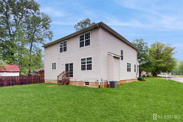 612 Magnolia Rd, North Brunswick, NJ 08902 - rear view of property with entry steps and central AC unit