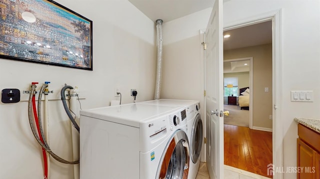 612 Magnolia Rd, North Brunswick, NJ 08902 - washroom with separate washer and dryer, light wood-style floors, and baseboards