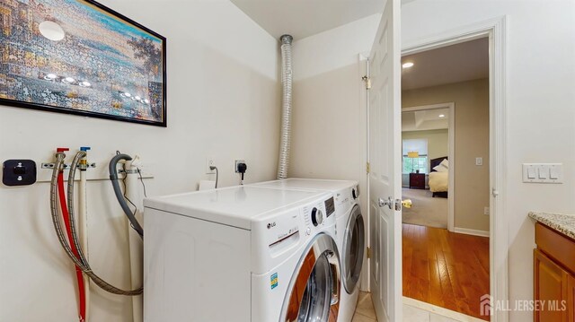 612 Magnolia Rd, North Brunswick, NJ 08902 - washroom with washer and dryer, light wood-type flooring, and baseboards