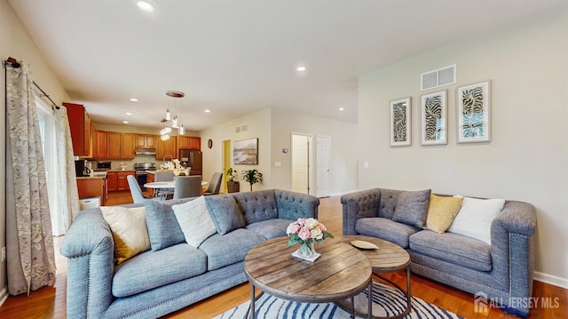 612 Magnolia Rd, North Brunswick, NJ 08902 - living room featuring light wood-style flooring, recessed lighting, and baseboards