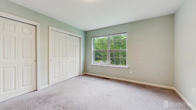 612 Magnolia Rd, North Brunswick, NJ 08902 - unfurnished bedroom featuring carpet floors, baseboards, and a closet