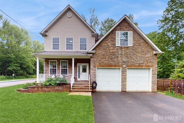 612 Magnolia Rd, North Brunswick, NJ 08902 - traditional-style house with asphalt driveway, stone siding, and a porch