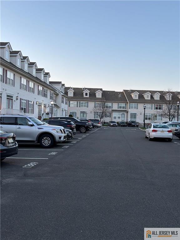 uncovered parking lot with a residential view