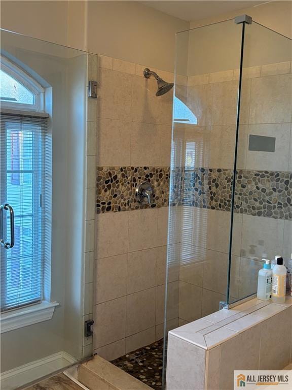 full bath with a shower stall
