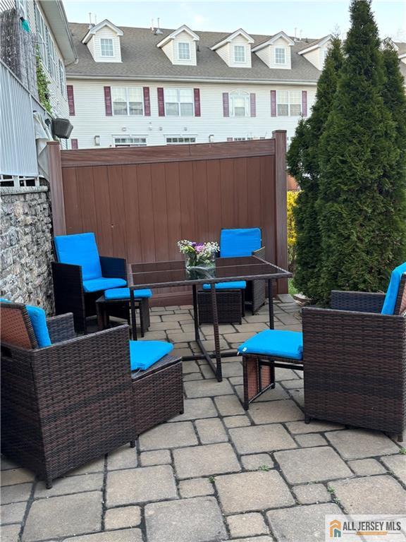 view of patio / terrace with an outdoor hangout area and fence