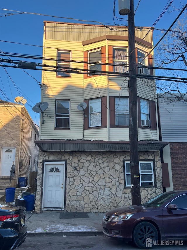 212 Hall Ave, Perth Amboy, NJ 08861 - view of front of home with cooling unit and stone siding
