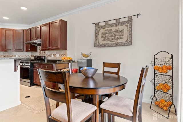 dining space with ornamental molding and recessed lighting
