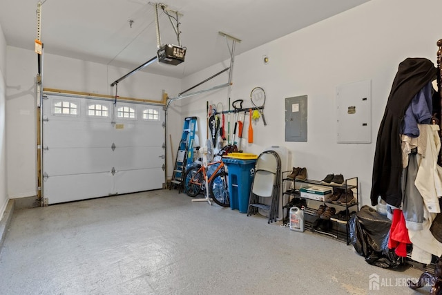 garage featuring electric panel and a garage door opener