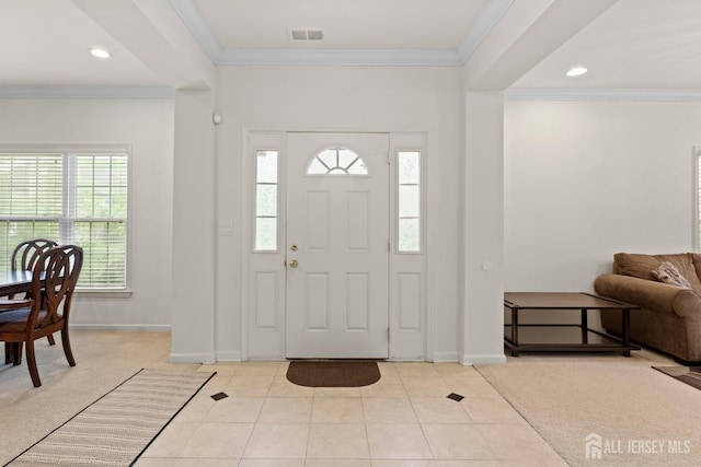 foyer entrance with ornamental molding, light tile patterned floors, and baseboards