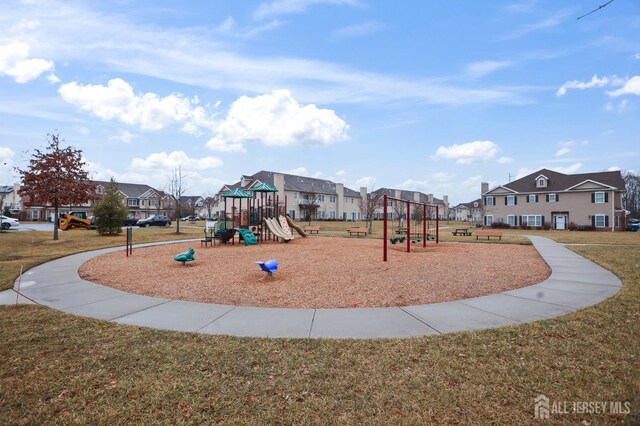 community playground featuring a yard and a residential view