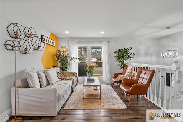 living room featuring a chandelier, recessed lighting, visible vents, and hardwood / wood-style floors