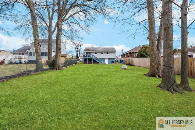 view of yard featuring stairs, a fenced backyard, and a wooden deck