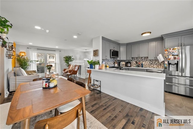 dining space with light wood-type flooring and recessed lighting