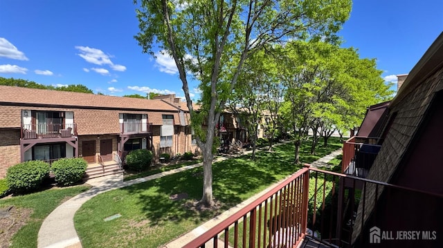 view of home's community with a lawn and a residential view