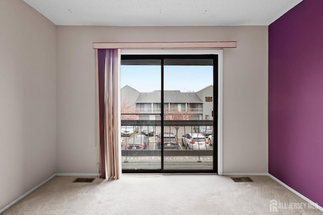 carpeted spare room with baseboards