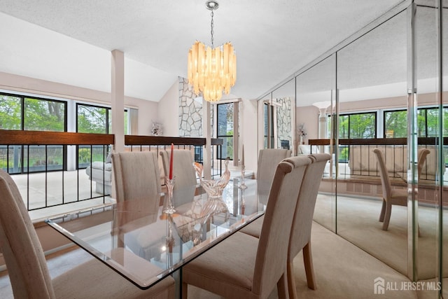 carpeted dining room featuring a chandelier, lofted ceiling, and a textured ceiling