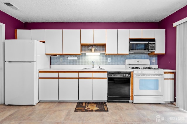 kitchen with black appliances, a sink, a textured ceiling, light countertops, and white cabinets