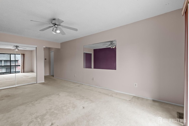 unfurnished bedroom with carpet flooring, baseboards, multiple closets, and ceiling fan