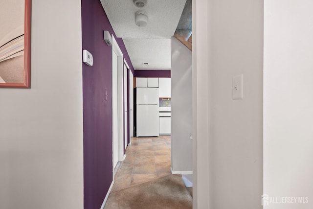 hall featuring baseboards