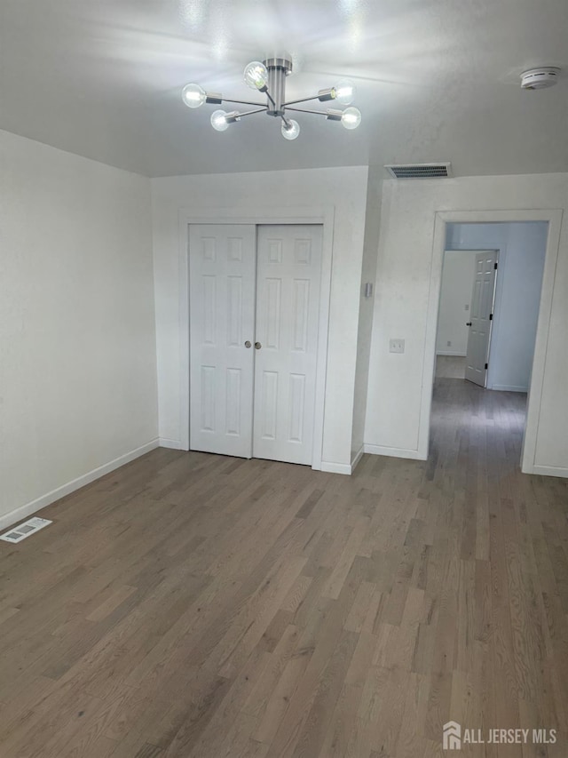 364 Myrtle St, Perth Amboy, NJ 08861 - unfurnished bedroom with wood finished floors, a chandelier, and a closet